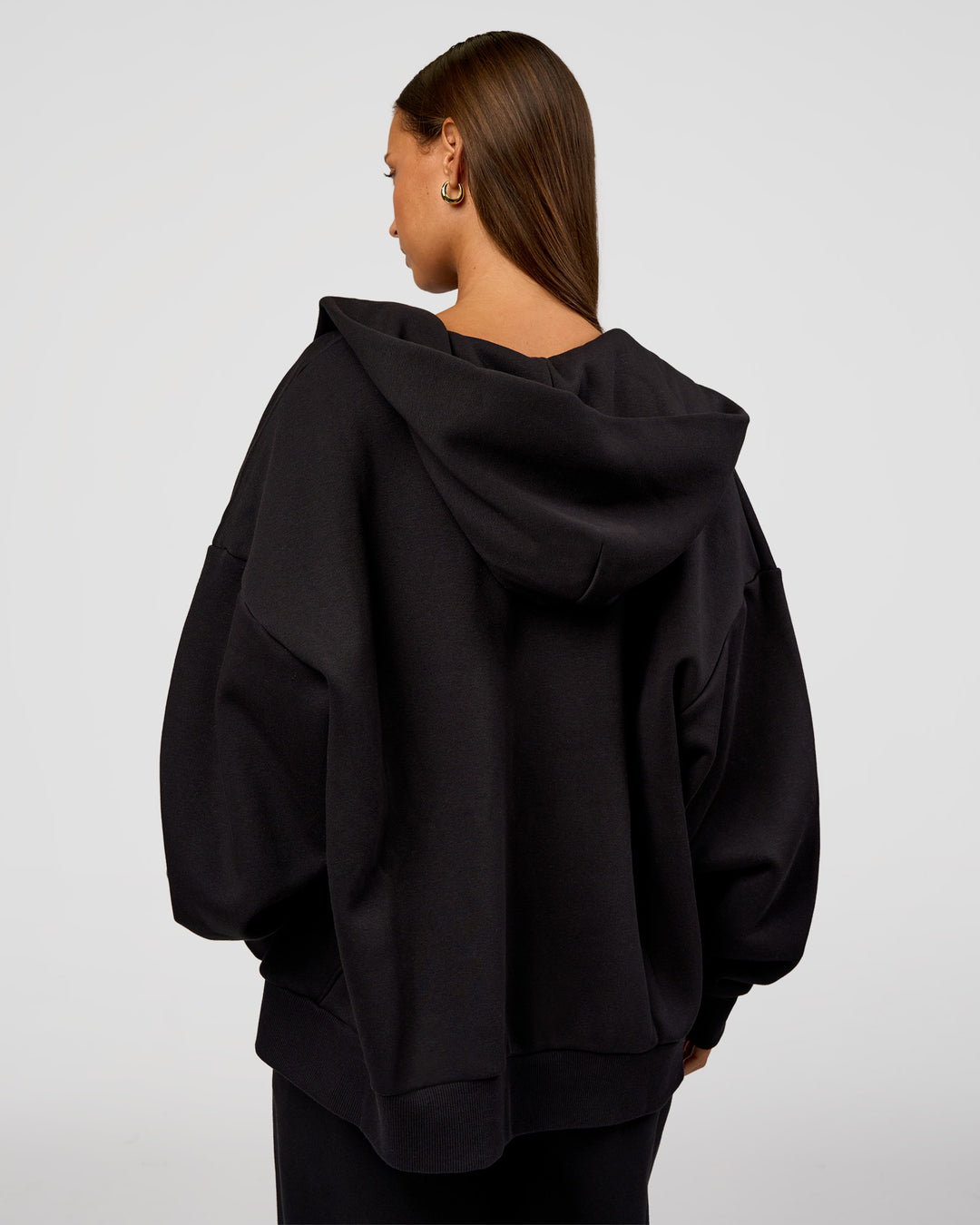 Woman wearing Base Zip Through Oversized Hoodie - Black | Model:Brylee | Size:XS - view 5