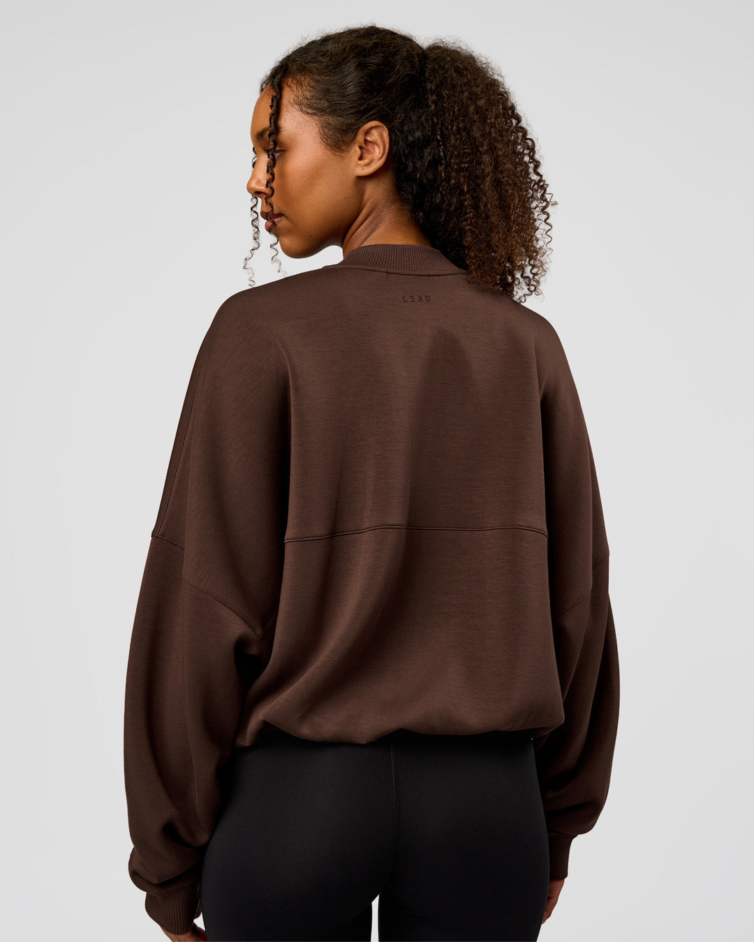 Woman wearing CF Elevate SoftTouch Bomber - Hot Chocolate | Model:Jordan | Size:XS - view 14