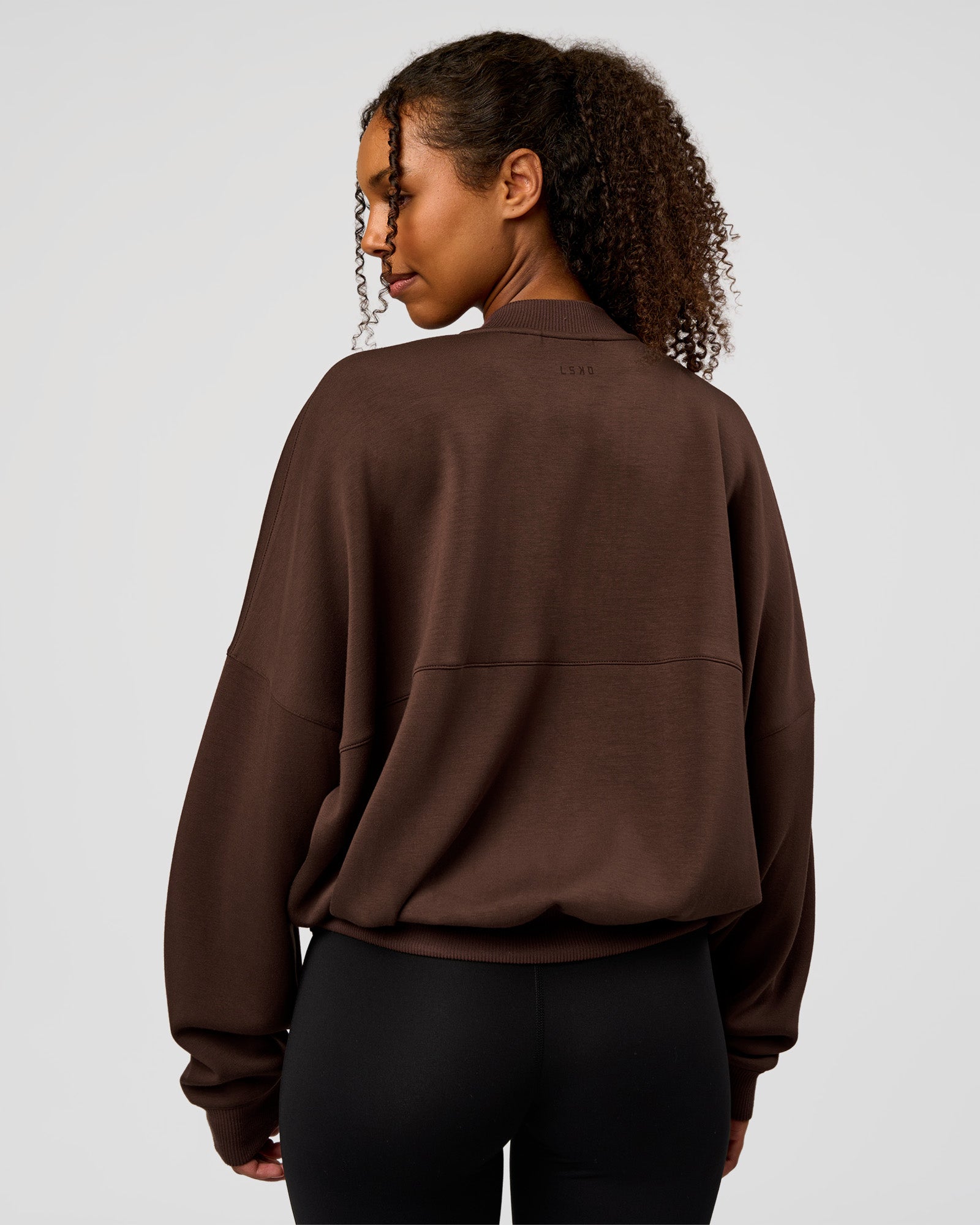 Woman wearing CF Elevate SoftTouch Bomber - Hot Chocolate | Model:Jordan | Size:XS