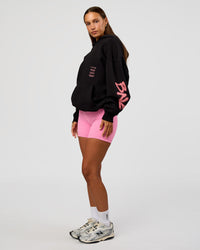 Woman wearing CFT BNE 26 Unisex Oversized Hoodie - Black-Candy Pink | Model:Brylee | Size:XS | Thumbnail Index: 10