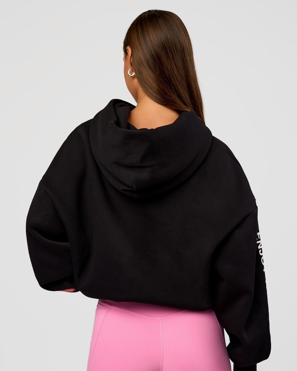 Woman wearing CFT BNE 26 Unisex Oversized Hoodie - Black-Candy Pink | Model:Brylee | Size:XS