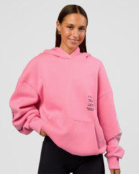 Woman wearing CFT BNE 26 Unisex Oversized Hoodie - Candy Pink-Black | Model:Brylee | Size:XS | Thumbnail Index: 4
