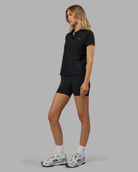 Woman wearing Drive Polo - Black | Model:Leilani| Size:XS | Thumbnail Index: 5