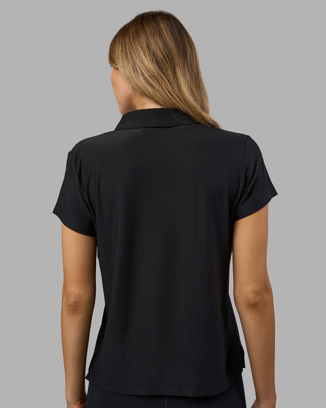 Woman wearing Drive Polo - Black | Model:Leilani| Size:XS - view 4