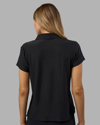 Woman wearing Drive Polo - Black | Model:Leilani| Size:XS | Thumbnail Index: 3