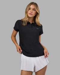 Woman wearing Drive Polo - Black | Model:Leilani| Size:XS | Thumbnail Index: 4