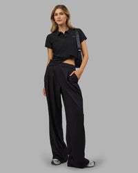 Woman wearing Drive Polo - Black | Model:Leilani| Size:XS | Thumbnail Index: 2