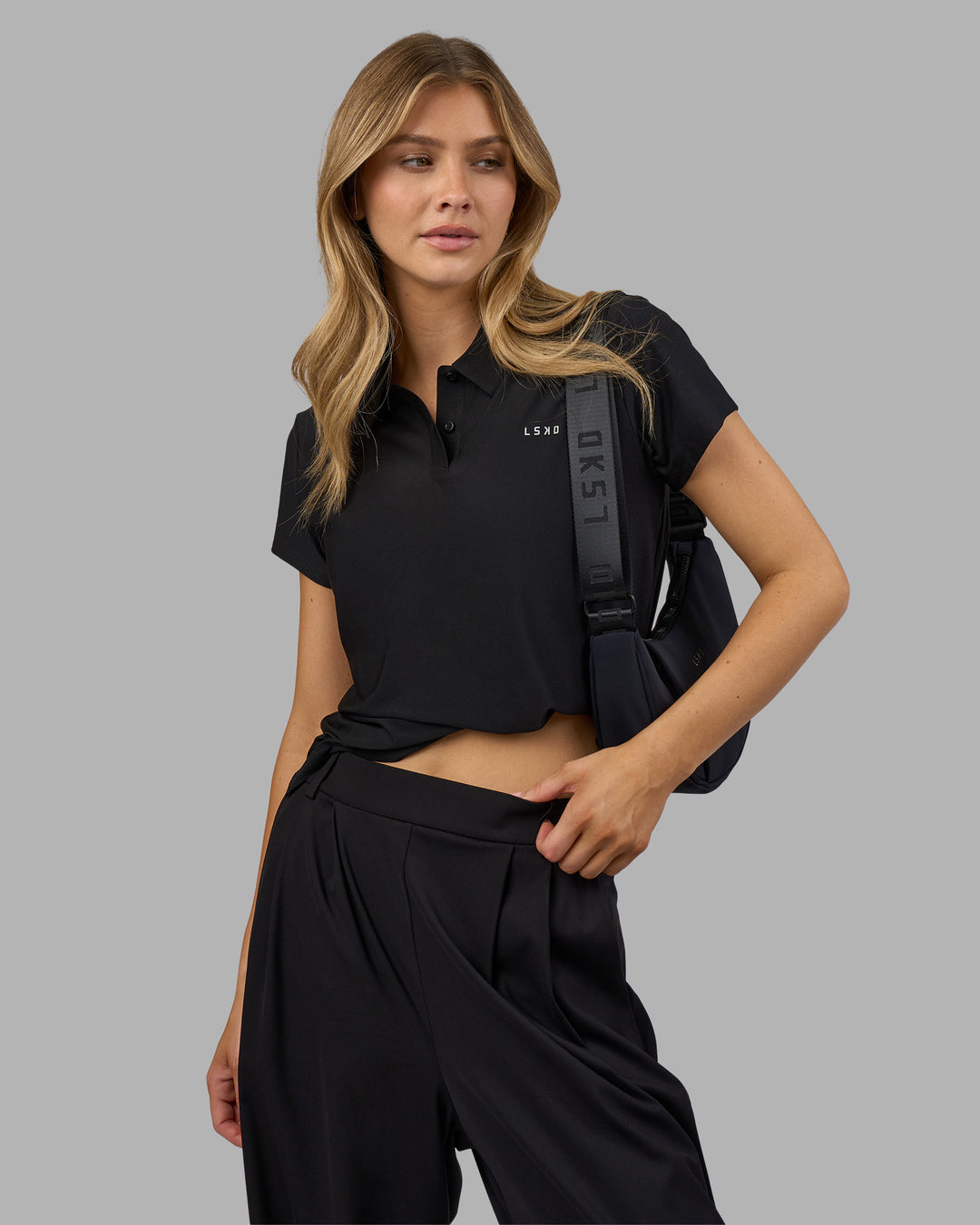 Woman wearing Drive Polo - Black | Model:Leilani| Size:XS - view 7