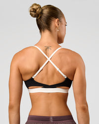 Man wearing Elevate Sports Bra - Black-Multi | Model:Maja | Size:XS | Thumbnail Index: 1
