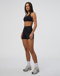 Woman wearing Elite High-Rise 4" Short Pockets - Black | Model:Eliza | Size:XS | Thumbnail Index: 4