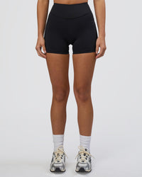 Woman wearing Elite High-Rise 4" Short Pockets - Black | Model:Eliza | Size:XS | Thumbnail Index: 6