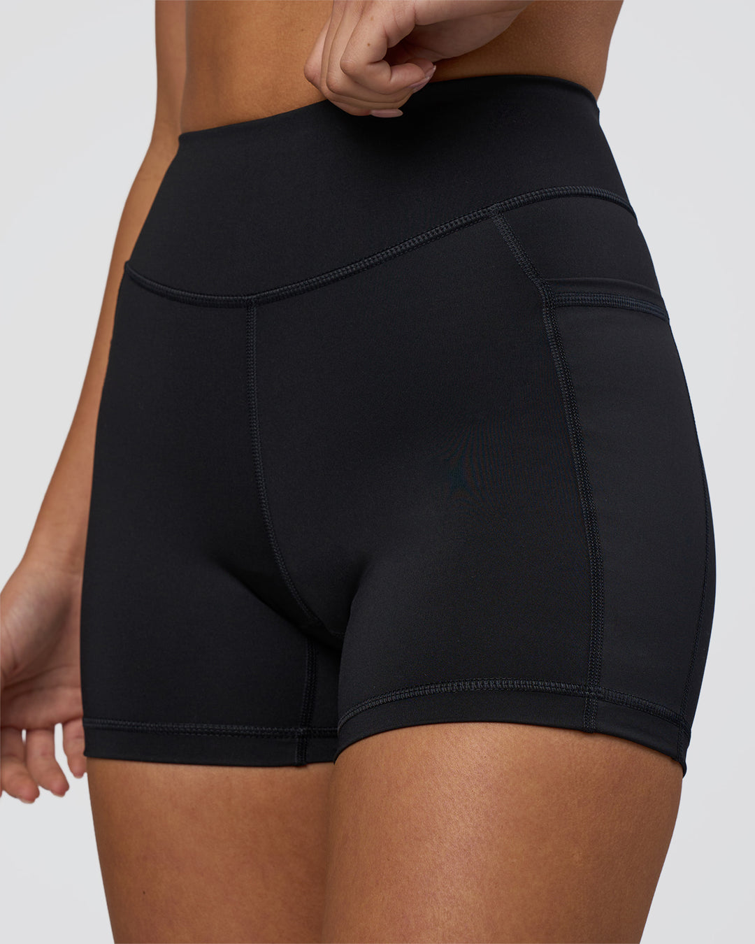 Woman wearing Elite High-Rise 4" Short Pockets - Black | Model:Eliza | Size:XS - view 6