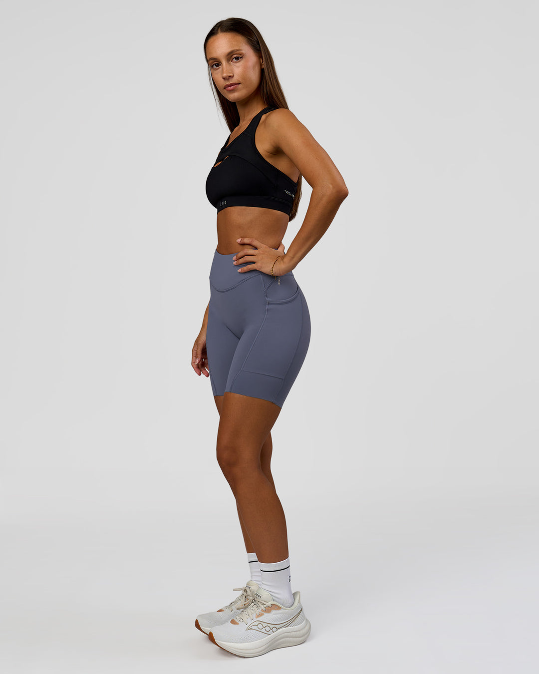 Woman wearing Elite Run High-Rise 7" Short Pockets - Night Shadow | Model:Brylee | Size:XS - view 6