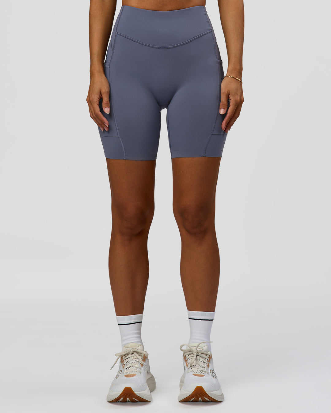 Woman wearing Elite Run High-Rise 7" Short Pockets - Night Shadow | Model:Brylee | Size:XS - view 1