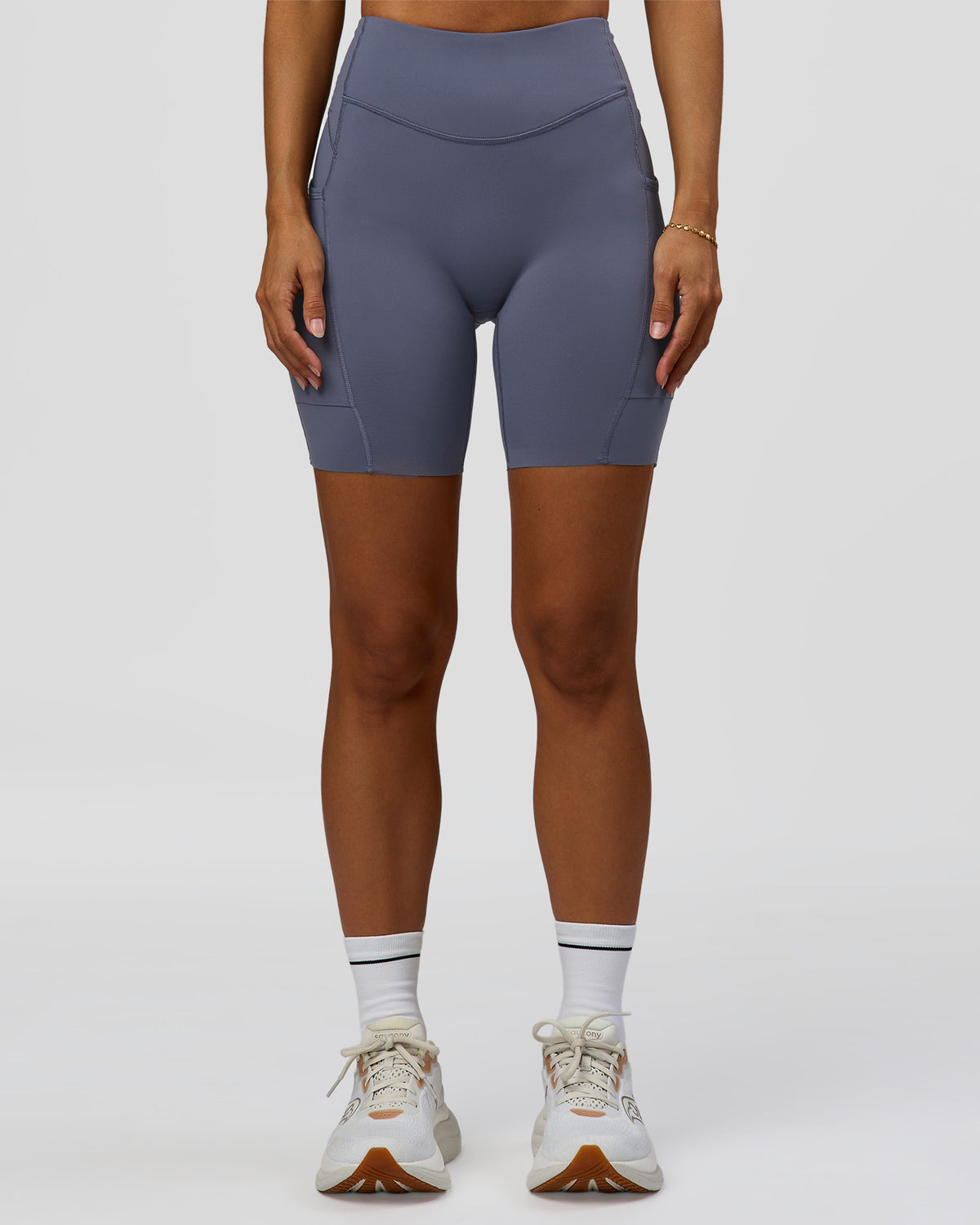 Woman wearing Elite Run High-Rise 7" Short Pockets - Night Shadow | Model:Brylee | Size:XS