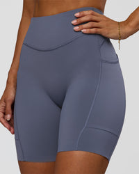 Woman wearing Elite Run High-Rise 7" Short Pockets - Night Shadow | Model:Brylee | Size:XS | Thumbnail Index: 3