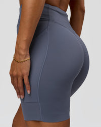 Woman wearing Elite Run High-Rise 7" Short Pockets - Night Shadow | Model:Brylee | Size:XS | Thumbnail Index: 6