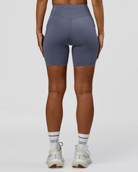 Woman wearing Elite Run High-Rise 7" Short Pockets - Night Shadow | Model:Brylee | Size:XS | Thumbnail Index: 8