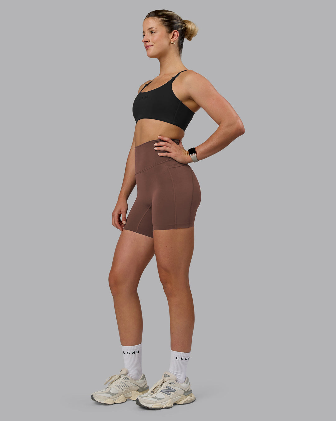 Woman wearing Elixir Ultra High-Rise 6" Short Pockets - Chocolate Martini | Model:Chloe | Size:XS - view 5