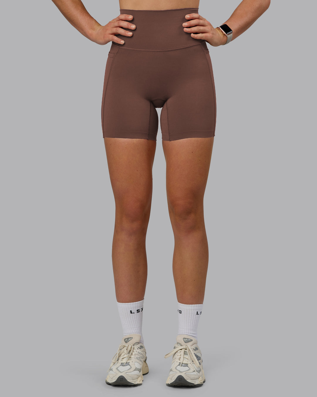 Woman wearing Elixir Ultra High-Rise 6" Short Pockets - Chocolate Martini | Model:Chloe | Size:XS - view 6