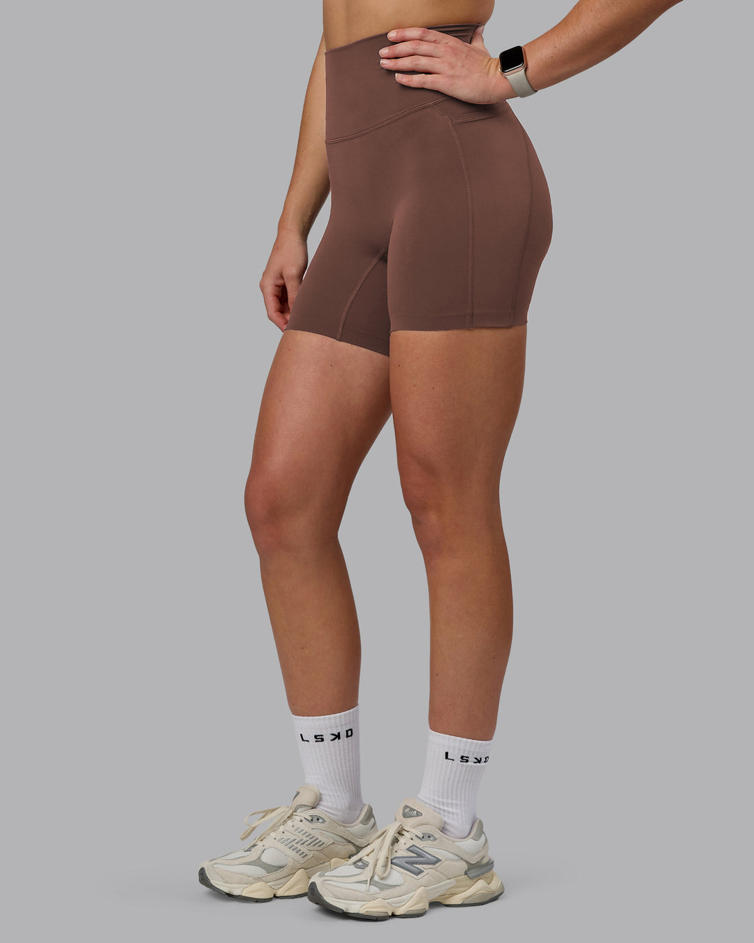 Woman wearing Elixir Ultra High-Rise 6" Short Pockets - Chocolate Martini | Model:Chloe | Size:XS - view 7
