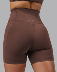Woman wearing Elixir Ultra High-Rise 6" Short Pockets - Chocolate Martini | Model:Chloe | Size:XS | Thumbnail Index: 7