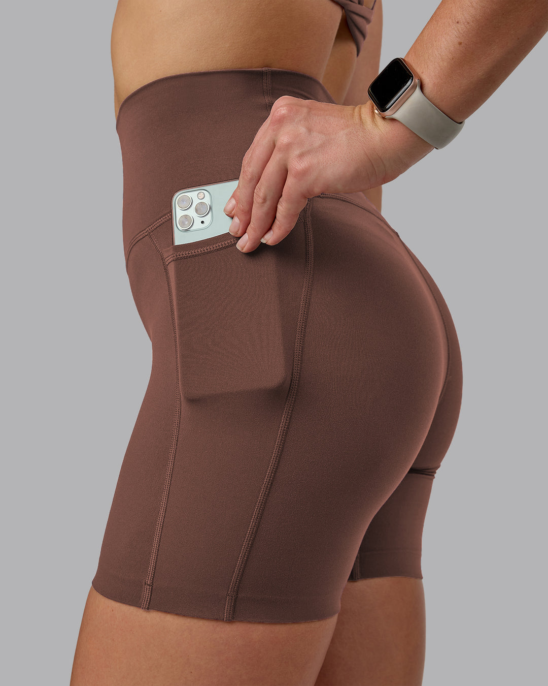 Woman wearing Elixir Ultra High-Rise 6" Short Pockets - Chocolate Martini | Model:Chloe | Size:XS - view 3