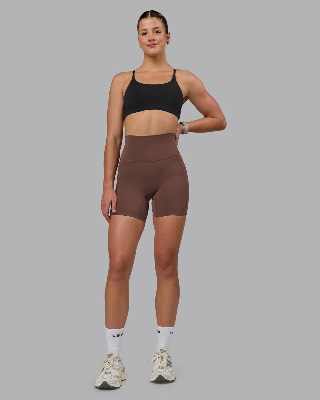 Woman wearing Elixir Ultra High-Rise 6" Short Pockets - Chocolate Martini | Model:Chloe | Size:XS - view 2