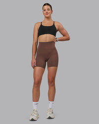 Woman wearing Elixir Ultra High-Rise 6" Short Pockets - Chocolate Martini | Model:Chloe | Size:XS | Thumbnail Index: 1