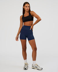 Woman wearing Elixir Ultra High-Rise 4" Short Pockets - Future Navy | Model:Brylee | Size:XS | Thumbnail Index: 4
