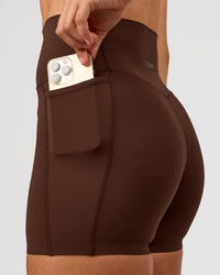Woman wearing Elixir Ultra High-Rise 4" Short Pockets - Hot Chocolate | Model:Maja | Size:XS | Thumbnail Index: 1