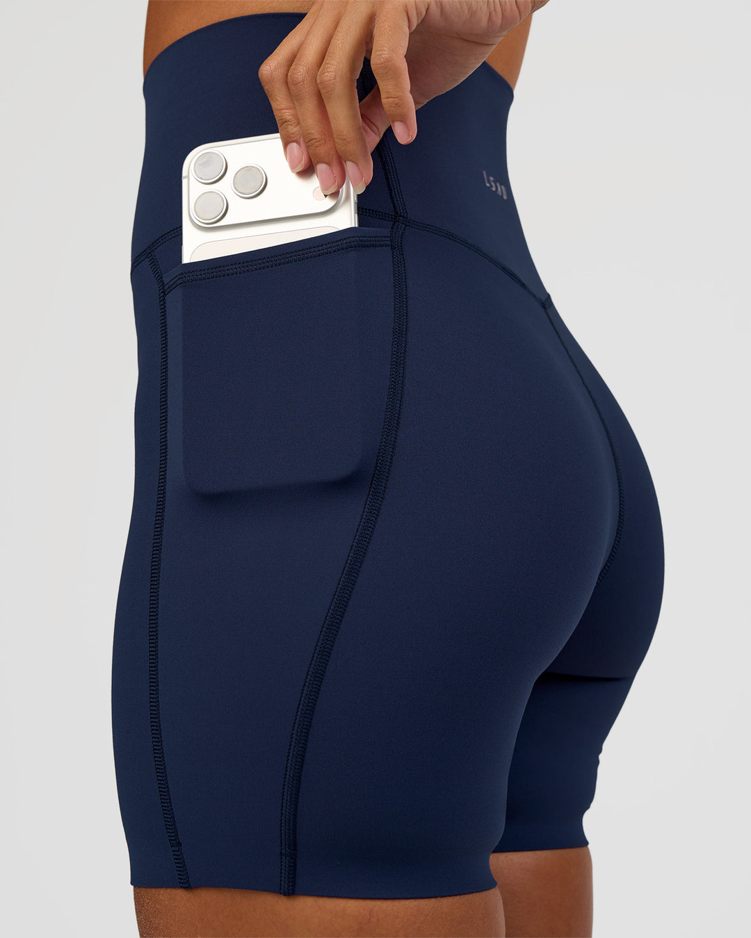 Woman wearing Elixir Ultra High-Rise 6” Short Pockets - Future Navy | Model:Brylee | Size:XS - view 2