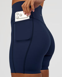 Woman wearing Elixir Ultra High-Rise 6” Short Pockets - Future Navy | Model:Brylee | Size:XS | Thumbnail Index: 1