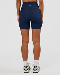 Woman wearing Elixir Ultra High-Rise 6” Short Pockets - Future Navy | Model:Brylee | Size:XS | Thumbnail Index: 3
