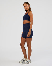 Woman wearing Elixir Ultra High-Rise 6” Short Pockets - Future Navy | Model:Brylee | Size:XS | Thumbnail Index: 5