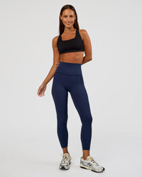 Woman wearing Elixir Ultra High-Rise 7/8 Legging Pockets - Future Navy | Model:Brylee | Size:XS | Thumbnail Index: 4