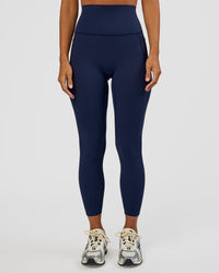 Woman wearing Elixir Ultra High-Rise 7/8 Legging Pockets - Future Navy | Model:Brylee | Size:XS | Thumbnail Index: 0