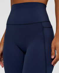 Woman wearing Elixir Ultra High-Rise 7/8 Legging Pockets - Future Navy | Model:Brylee | Size:XS | Thumbnail Index: 5