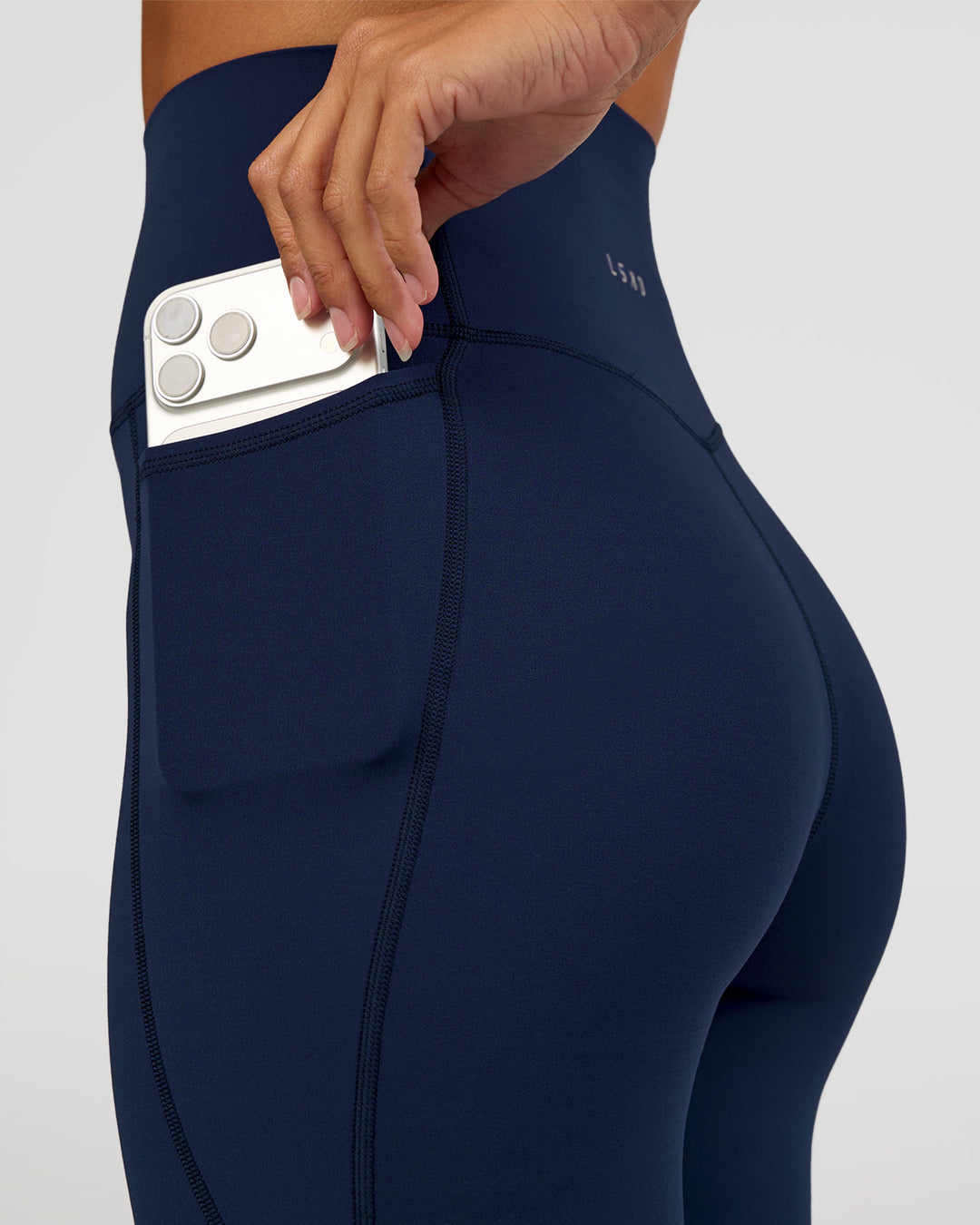 Woman wearing Elixir Ultra High-Rise 7/8 Legging Pockets - Future Navy | Model:Brylee | Size:XS - view 3