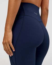 Woman wearing Elixir Ultra High-Rise 7/8 Legging Pockets - Future Navy | Model:Brylee | Size:XS | Thumbnail Index: 7
