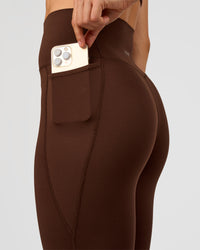 Woman wearing Elixir Ultra High-Rise 7/8 Legging Pockets - Hot Chocolate | Model:Maja | Size:XS | Thumbnail Index: 5