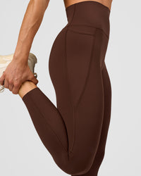 Woman wearing Elixir Ultra High-Rise 7/8 Legging Pockets - Hot Chocolate | Model:Maja | Size:XS | Thumbnail Index: 1