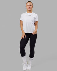 Woman wearing Fitstop Fast Tee - White | Thumbnail Index: 1