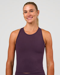 Woman wearing Flow Performance Tank 2.0 - Midnight Plum | Model:Emelia | Size:XS | Thumbnail Index: 1