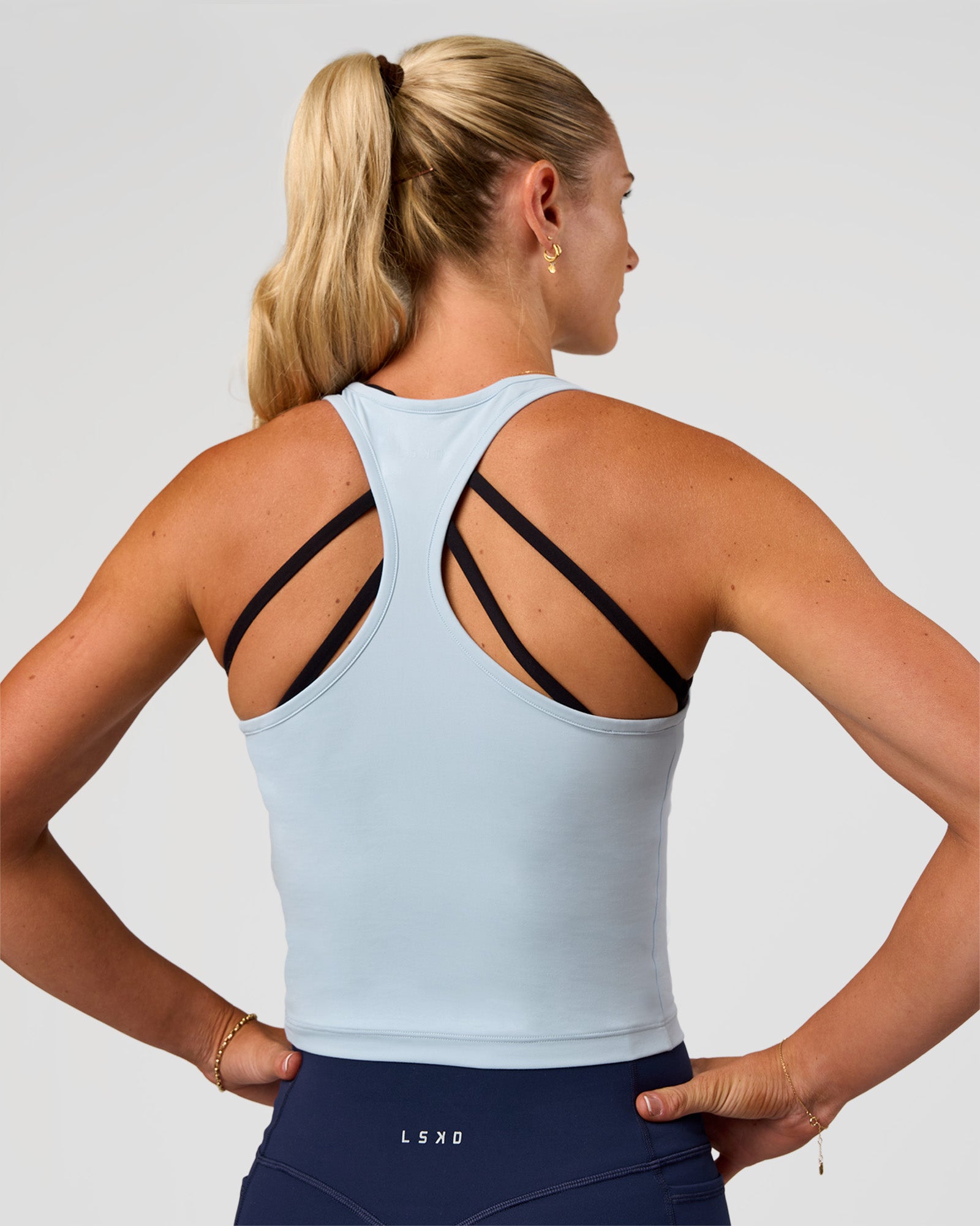 Woman wearing Flow Scoop Neck Performance Tank - Blue Aura | Model:Emelia | Size:XS