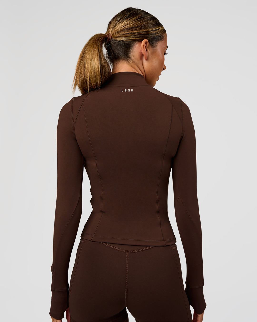 Woman wearing Fusion Active Jacket - Hot Chocolate | Model:Charli | Size:XS - view 5