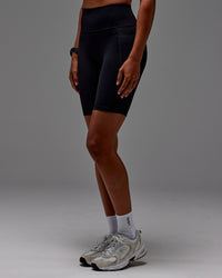 Woman wearing Fusion Ultra High-Rise 9" Short Pockets - Black | Model:Txai | Size:XS | Thumbnail Index: 21