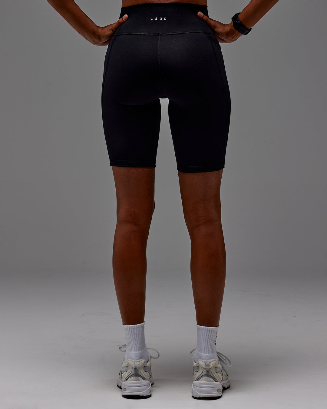 Woman wearing Fusion Ultra High-Rise 9" Short Pockets - Black | Model:Txai | Size:XS - view 18
