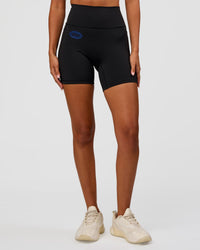 Woman wearing Fusion Hype Graphic Ultra High-Rise 6" Short Pockets - Black-Electric Indigo | Model:Charli | Size:XS | Thumbnail Index: 0