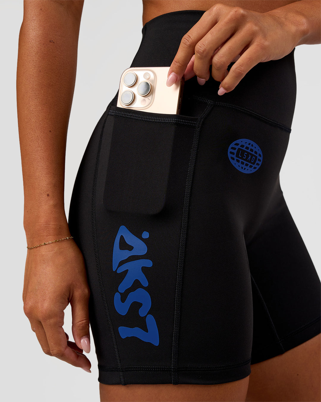 Woman wearing Fusion Hype Graphic Ultra High-Rise 6" Short Pockets - Black-Electric Indigo | Model:Charli | Size:XS - view 3